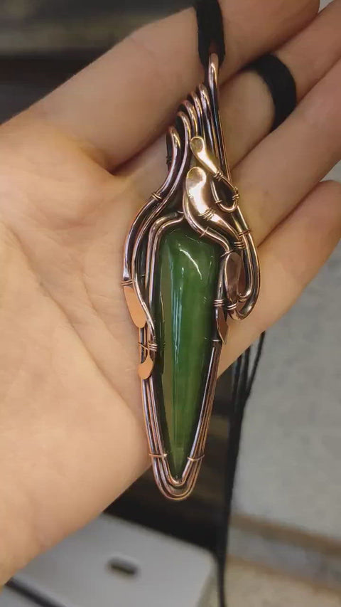 Artisan made copper pendant with a natural jade stone.