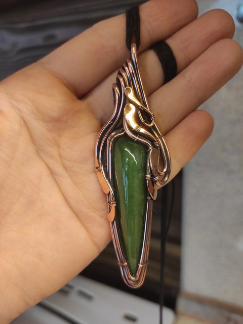 Artisan made copper pendant with a natural jade stone.